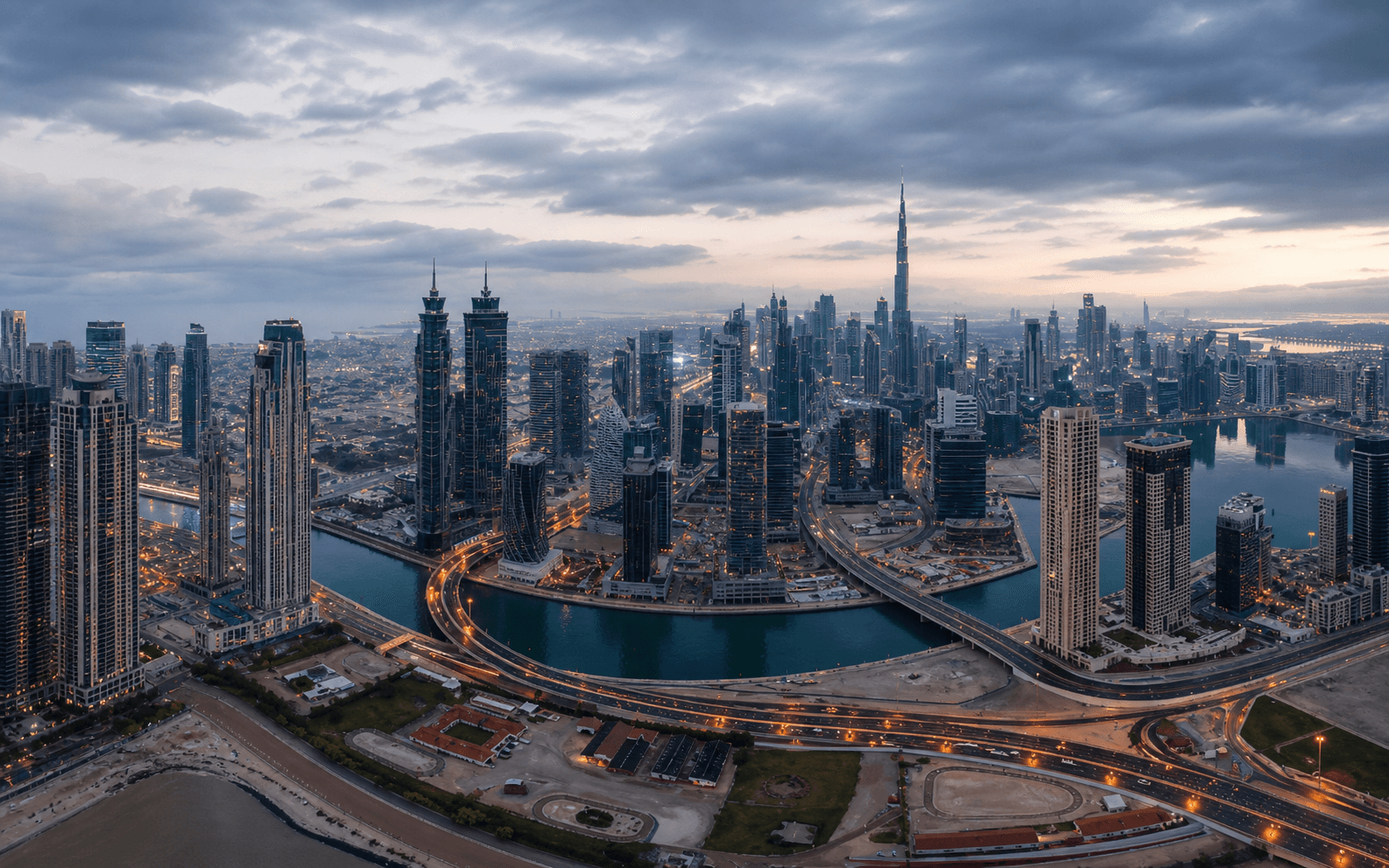 Aerial view of Dubai's skyline and waterways at dusk
